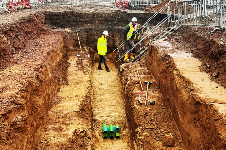 Our team is in a deep excavation on a building site for utility pipes to be laid. DDG Group groundworks.